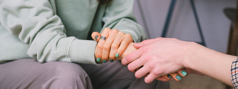 two people hold hands