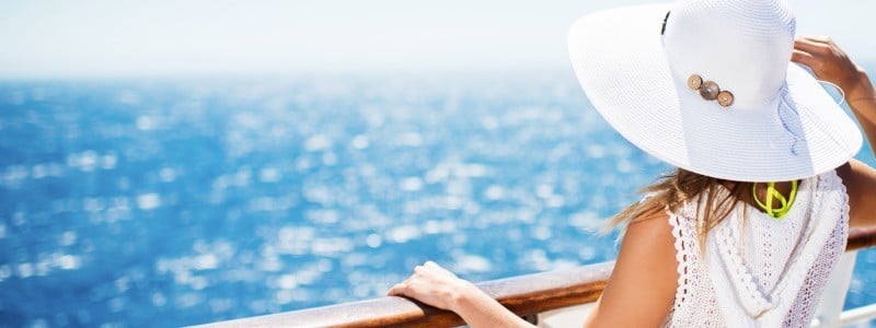 a lady looks at the sea on a cruise ship